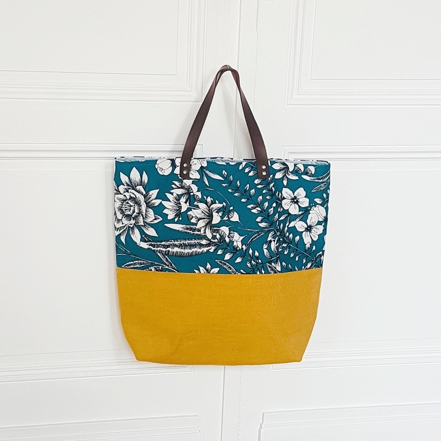 a blue and yellow bag on a white door